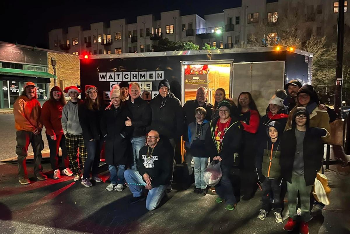 The team and the people they serve gathered at the trailer at night