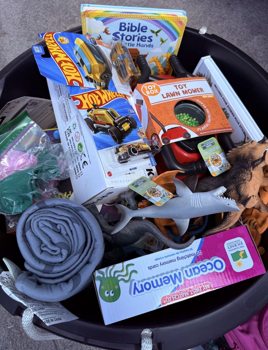 A bin filled with new toys, games and childrens books